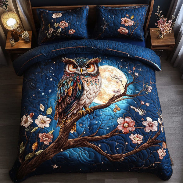 Owl Wisdom quilted 3-piece bedding set on a made bed with two matching pillow shams