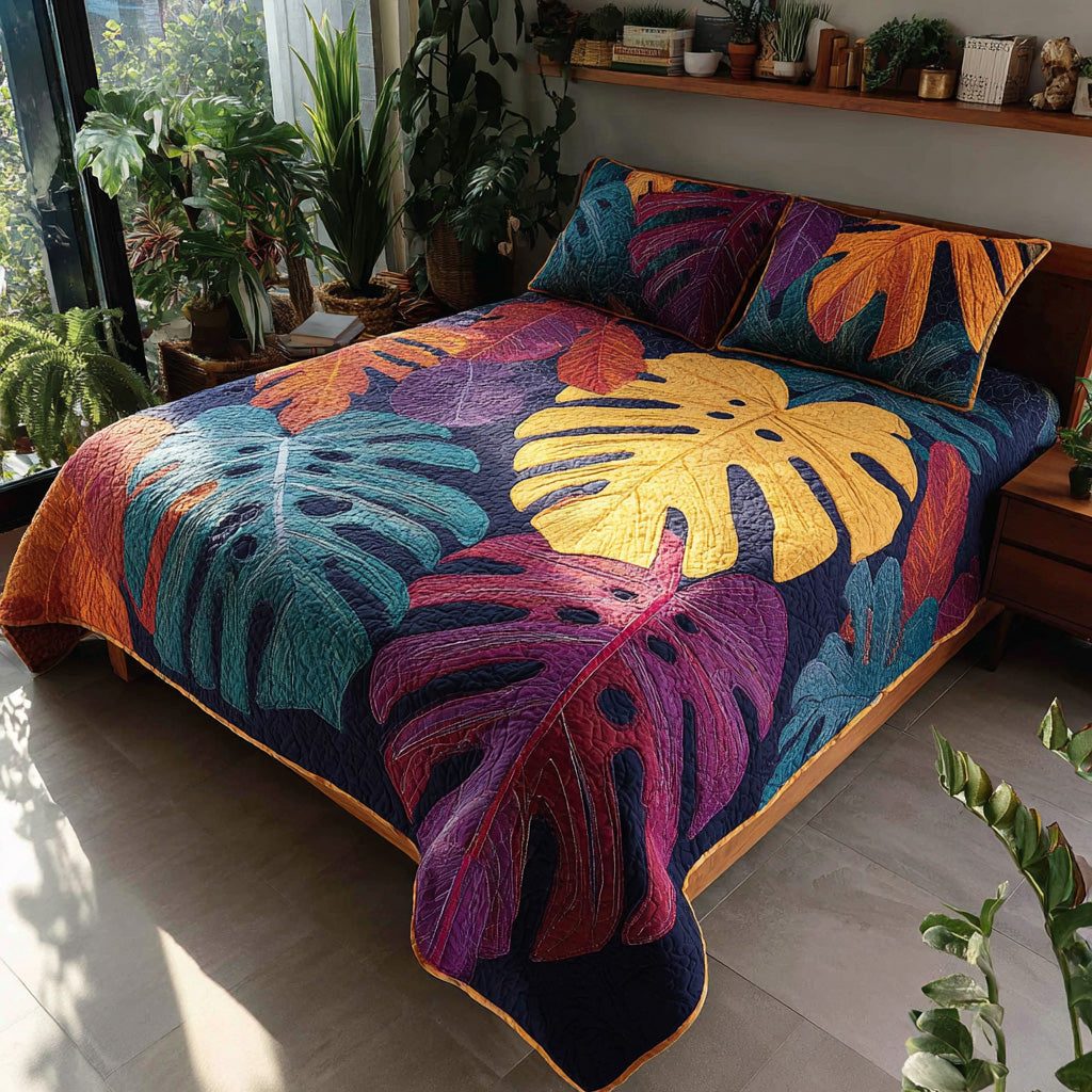 Painted Monstera quilted 3-piece bedding set on a made bed with two matching pillow shams