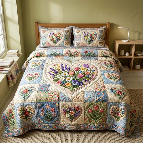 Pastel Bloom quilted 3-piece bedding set on a made bed with two matching pillow shams
