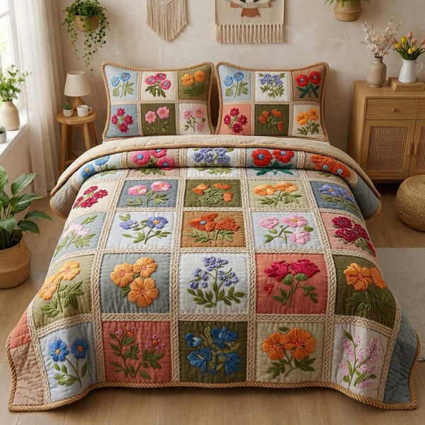 Pastel Blossoms quilted 3-piece bedding set on a made bed with two matching pillow shams