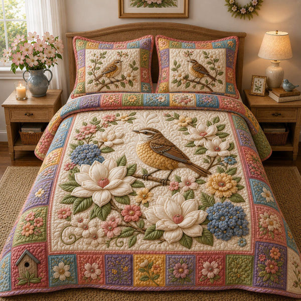 Pastel Wildflower Wren quilted 3-piece bedding set on a made bed with two matching pillow shams