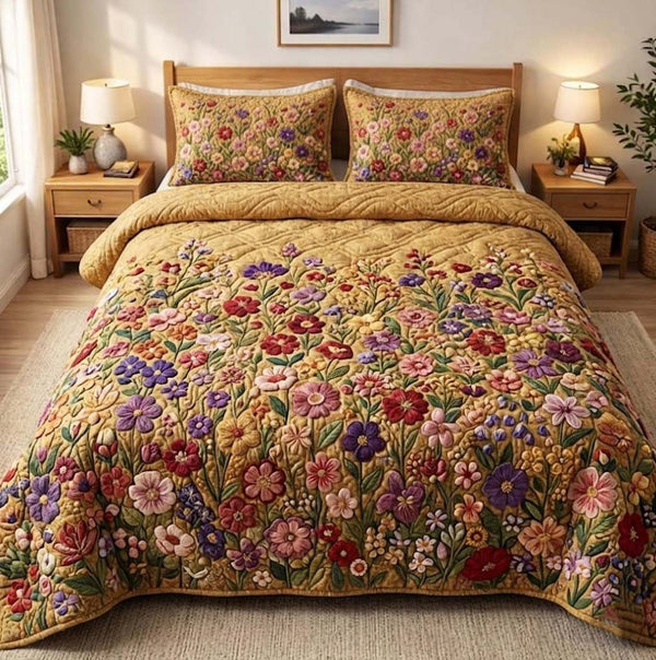 Patchy Bloom quilted 3-piece bedding set on a made bed with two matching pillow shams
