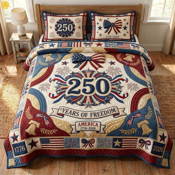 Patriotic Bows quilted 3-piece bedding set on a made bed in a warmly lit bedroom