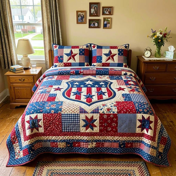 Patriotic Shield Star quilted 3-piece bedding set on a made bed in a warmly lit bedroom