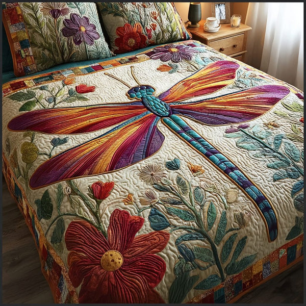 Peaceful Dragonfly quilted 3-piece bedding set on a made bed with two matching pillow shams