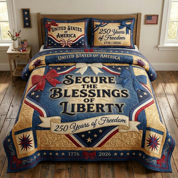 People Freedom quilted 3-piece bedding set on a made bed in a warmly lit bedroom
