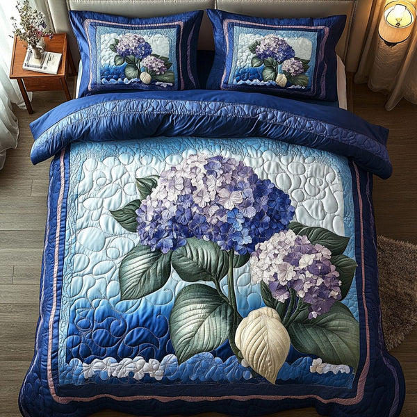 Petal Paradise quilted 3-piece bedding set on a made bed with two matching pillow shams