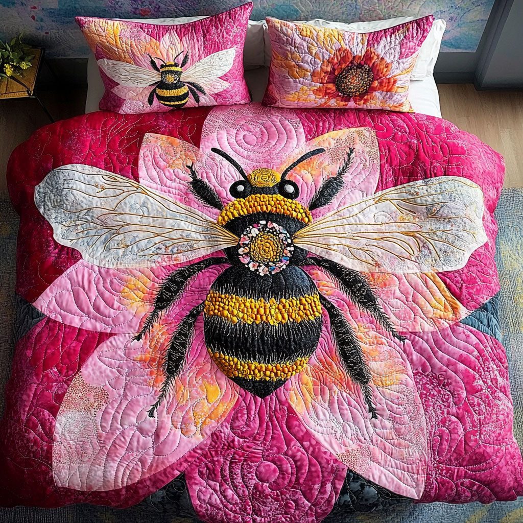 Pink Bloom Bee quilted 3-piece bedding set on a made bed with two matching pillow shams