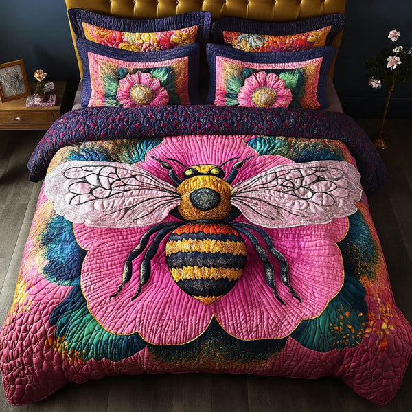Pink Bloom Buzz quilted 3-piece bedding set on a made bed with two matching pillow shams
