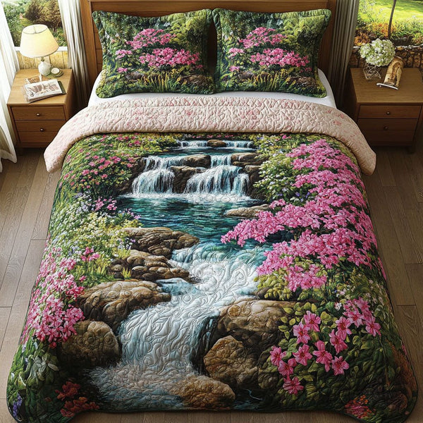 Pink Blossom Falls quilted 3-piece bedding set on a made bed with two matching pillow shams