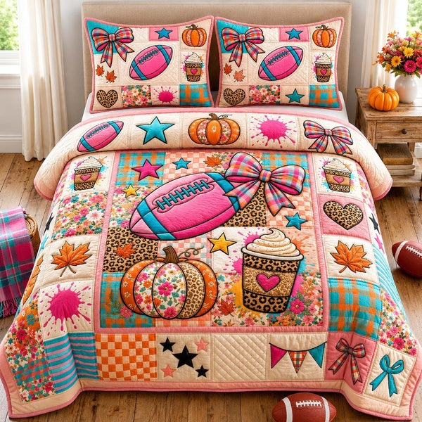 Pink Football Fall quilted 3-piece bedding set on a made bed with two matching pillow shams
