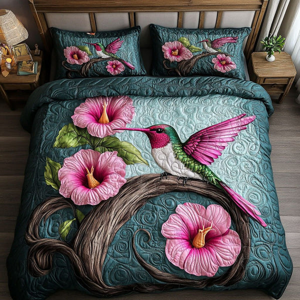 Pink Hummingbird quilted 3-piece bedding set on a made bed with two matching pillow shams