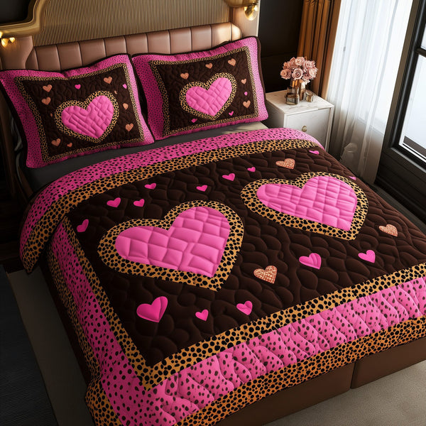 Pink Leopard Heart quilted 3-piece bedding set on a made bed with two matching pillow shams