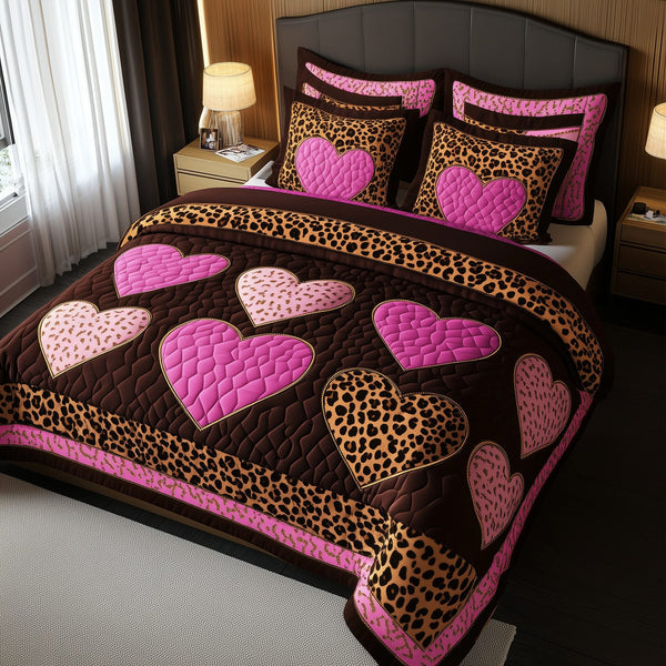 Pink Leopard Heart quilted 3-piece bedding set on a made bed with two matching pillow shams