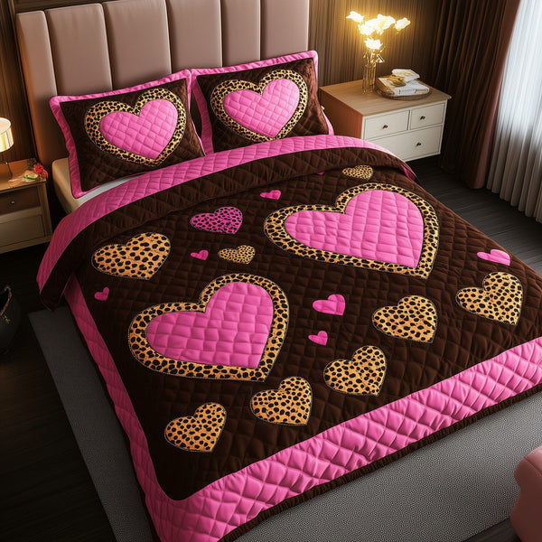 Pink Leopard Heart quilted 3-piece bedding set on a made bed with two matching pillow shams
