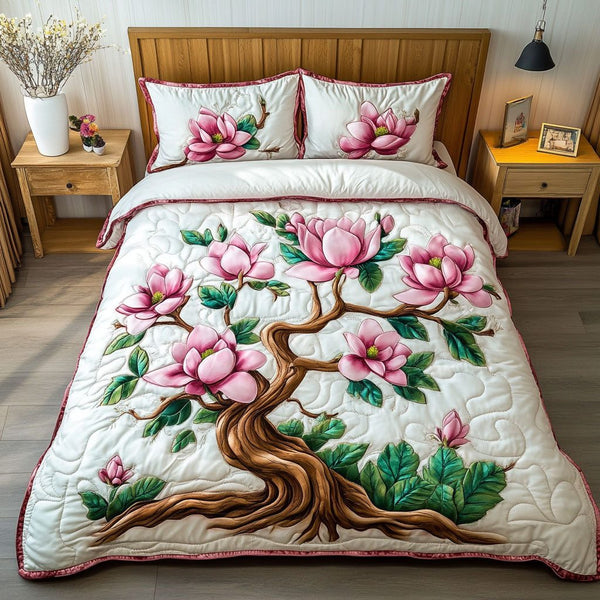 Pink Magnolia Dreams quilted 3-piece bedding set on a made bed with two matching pillow shams