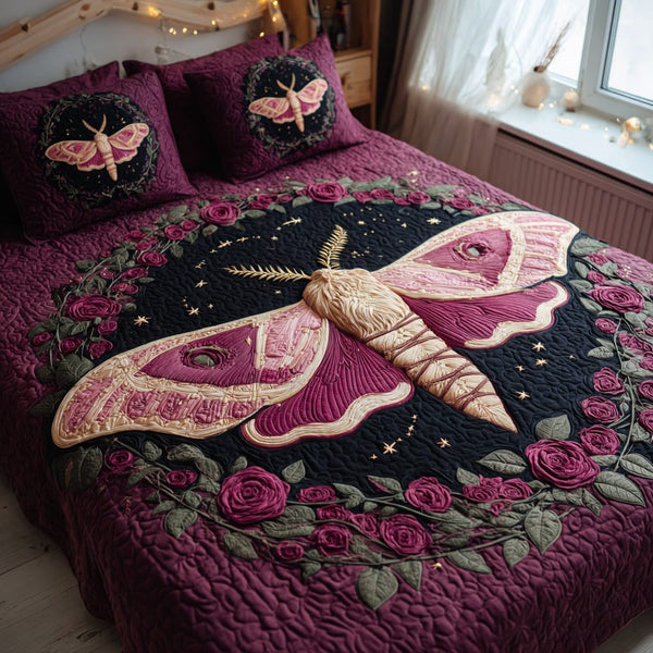 Pink Moth quilted 3-piece bedding set on a made bed with two matching pillow shams