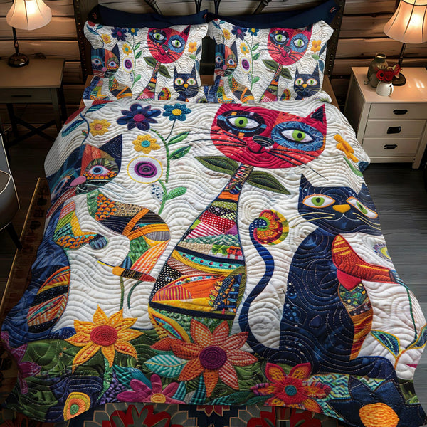 Playful Cats In The Garden quilted 3-piece bedding set on a made bed with two matching pillow shams