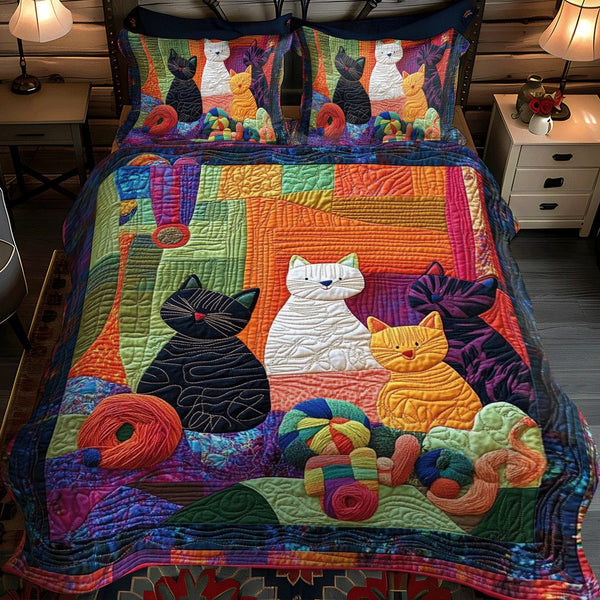 Playful Floral Cats quilted 3-piece bedding set on a made bed with two matching pillow shams