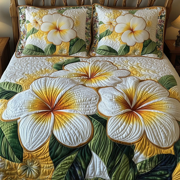 Plumeria Dreams quilted 3-piece bedding set on a made bed with two matching pillow shams