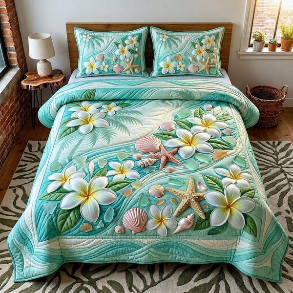 Plumeria Dreams quilted 3-piece bedding set on a made bed with two matching pillow shams