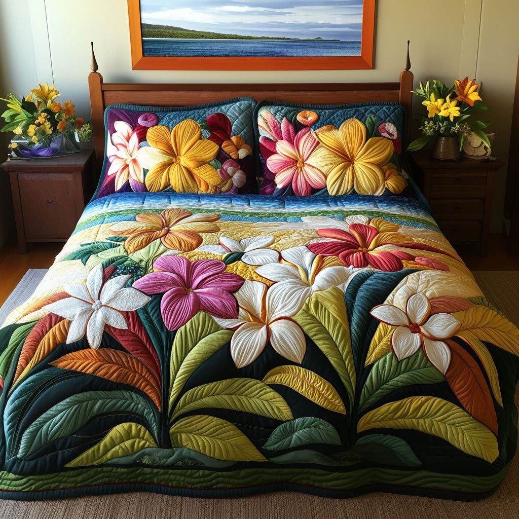 Plumeria Garden quilted 3-piece bedding set on a made bed with two matching pillow shams