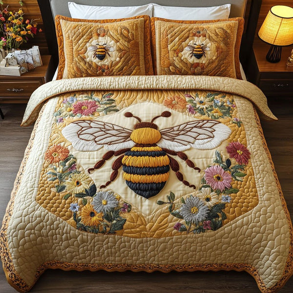 Pollen Dancer quilted 3-piece bedding set on a made bed with two matching pillow shams