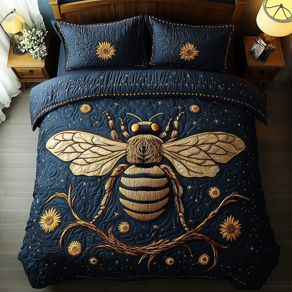Pollinator Charm quilted 3-piece bedding set on a made bed with two matching pillow shams