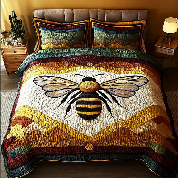 Pollinator Charm quilted 3-piece bedding set on a made bed with two matching pillow shams