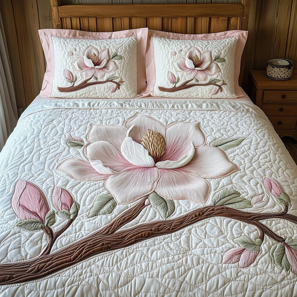 Pure Magnolia Beauty quilted 3-piece bedding set on a made bed with two matching pillow shams