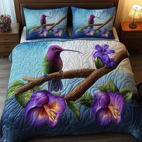 Purple Hummingbird quilted 3-piece bedding set on a made bed with two matching pillow shams