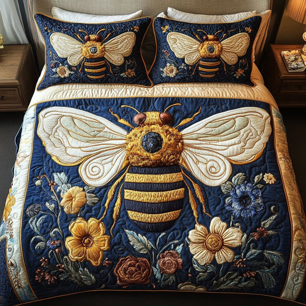 Queen Bee Garden quilted 3-piece bedding set on a made bed with two matching pillow shams