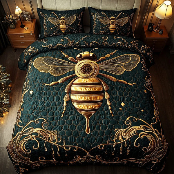 Queen Bee Glory quilted 3-piece bedding set on a made bed with two matching pillow shams