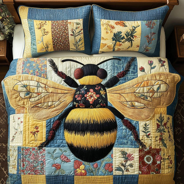 Queen Bee quilted 3-piece bedding set on a made bed with two matching pillow shams