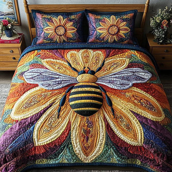 Radiant Bee Essence quilted 3-piece bedding set on a made bed with two matching pillow shams
