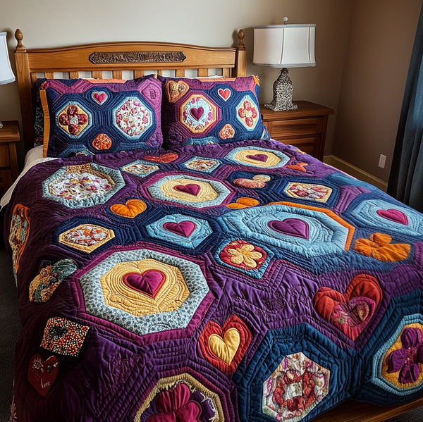 Radiant Hearts quilted 3-piece bedding set on a made bed with two matching pillow shams