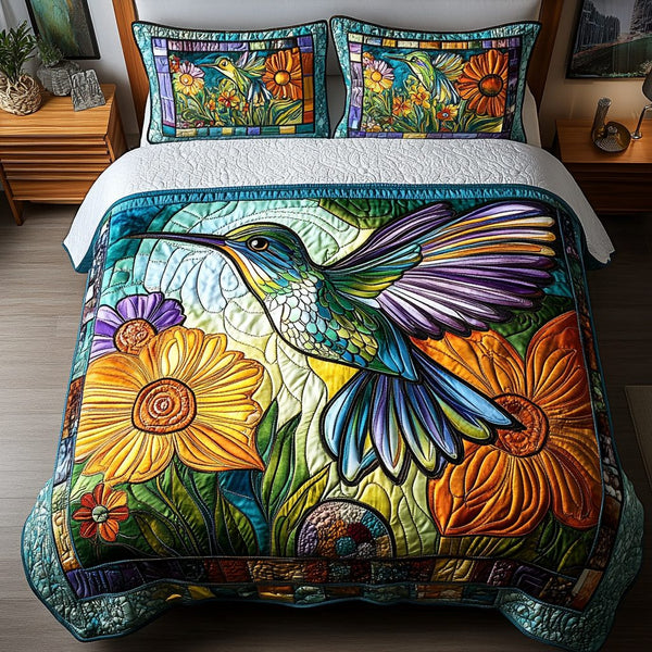 Rainbow Glider quilted 3-piece bedding set on a made bed with two matching pillow shams