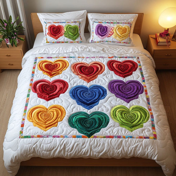 Rainbow Hearts quilted 3-piece bedding set on a made bed with two matching pillow shams