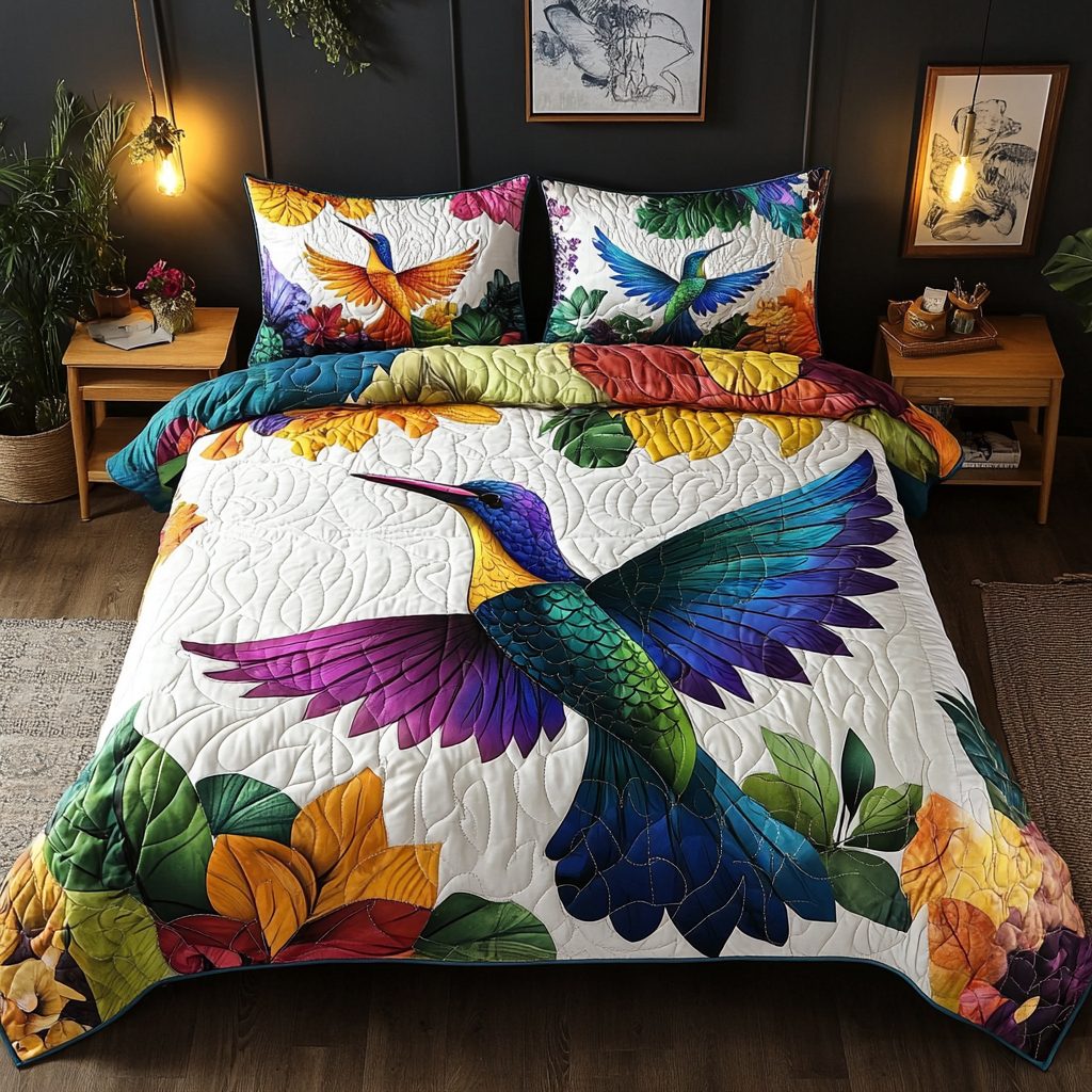Rainbow Hummingbird Bliss quilted 3-piece bedding set on a made bed with two matching pillow shams