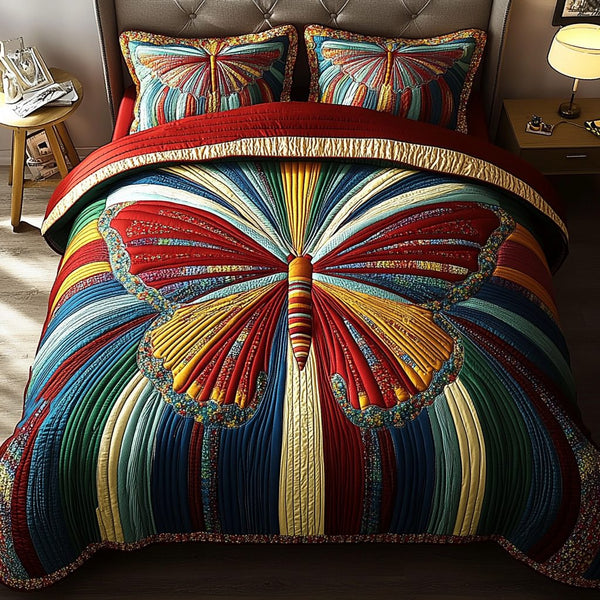 Rainbow Wings quilted 3-piece bedding set on a made bed with two matching pillow shams