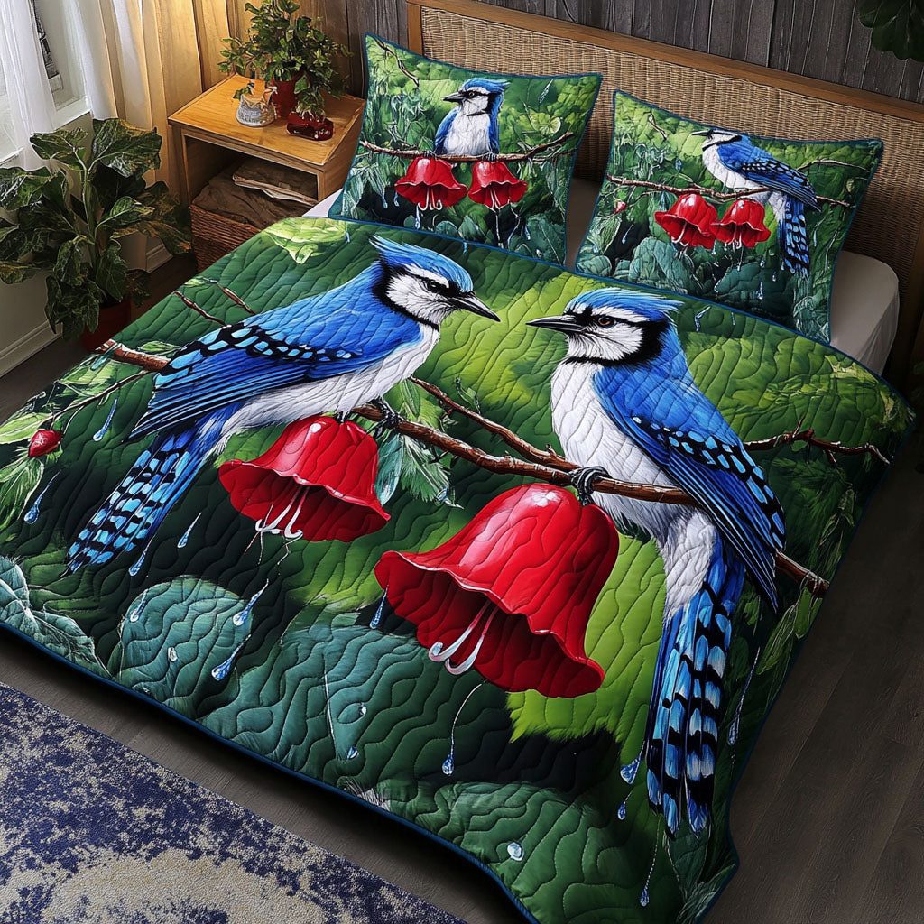 Raindrop Serenade Jays quilted 3-piece bedding set on a made bed with two matching pillow shams