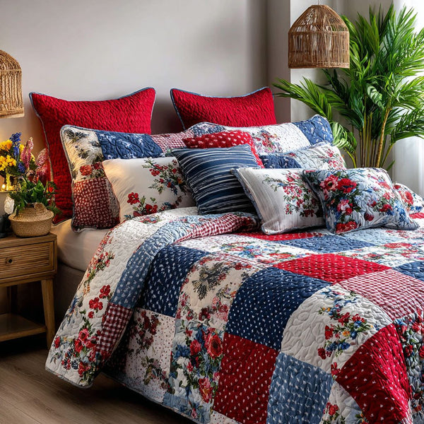 Red Blue Glory quilted 3-piece bedding set on a made bed with two matching pillow shams