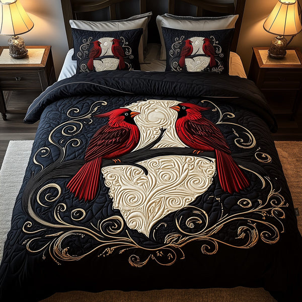 Red Cardinal Couple quilted 3-piece bedding set on a made bed with two matching pillow shams