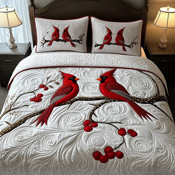 Red Cardinal Couple quilted 3-piece bedding set on a made bed with two matching pillow shams