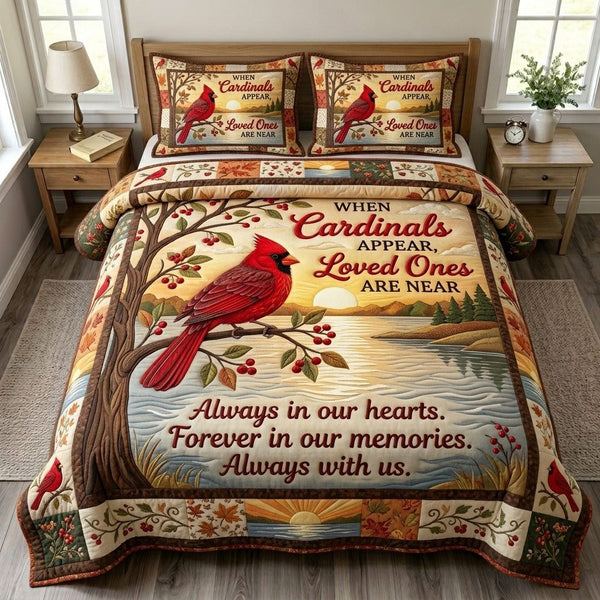 Red Cardinal quilted 3-piece bedding set on a made bed with two matching pillow shams