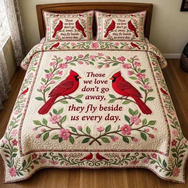 Red Cardinal quilted 3-piece bedding set on a made bed with two matching pillow shams