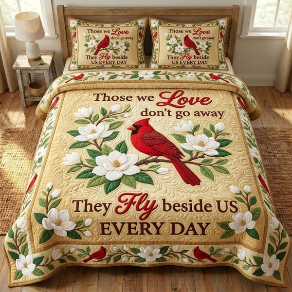Red Cardinal quilted 3-piece bedding set on a made bed with two matching pillow shams