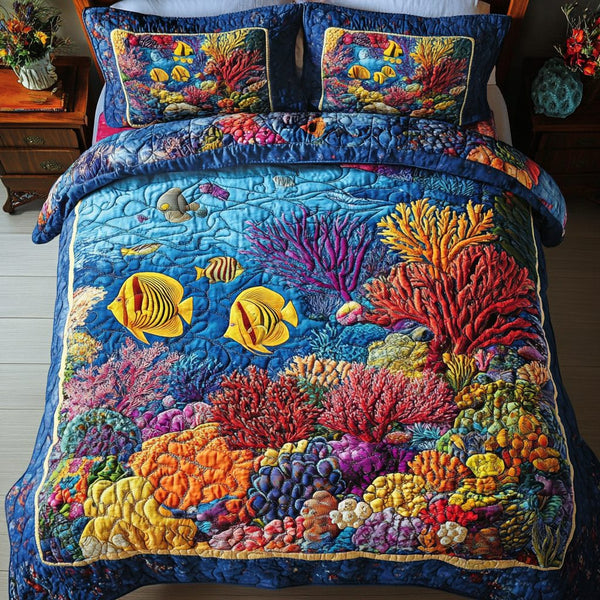 Reef Radiance quilted 3-piece bedding set on a made bed in a light coastal bedroom