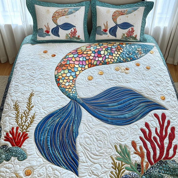 Reef Romance quilted 3-piece bedding set on a made bed in a light coastal bedroom