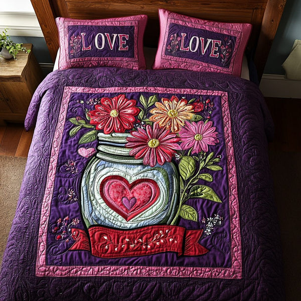 Romance in Bloom quilted 3-piece bedding set on a made bed with two matching pillow shams